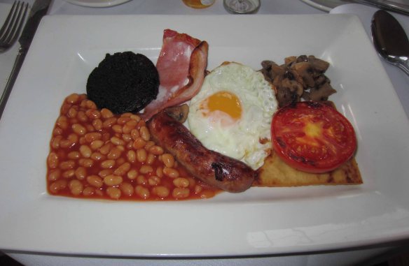 The dreaded full English breakfast. Top left: black pudding. Bottom right (under the tomato): fried spud
