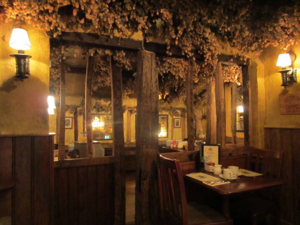 The thirteenth century interior of the Black Horse Inn with dried hops decorating its ceiling beams. 